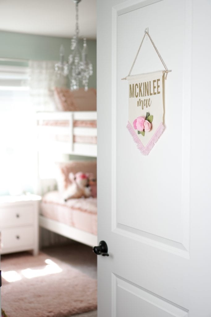 Big girls bedroom update with bunk beds, pink bedding by Beddy's Beds, chandeliers, gold and aqua accents.