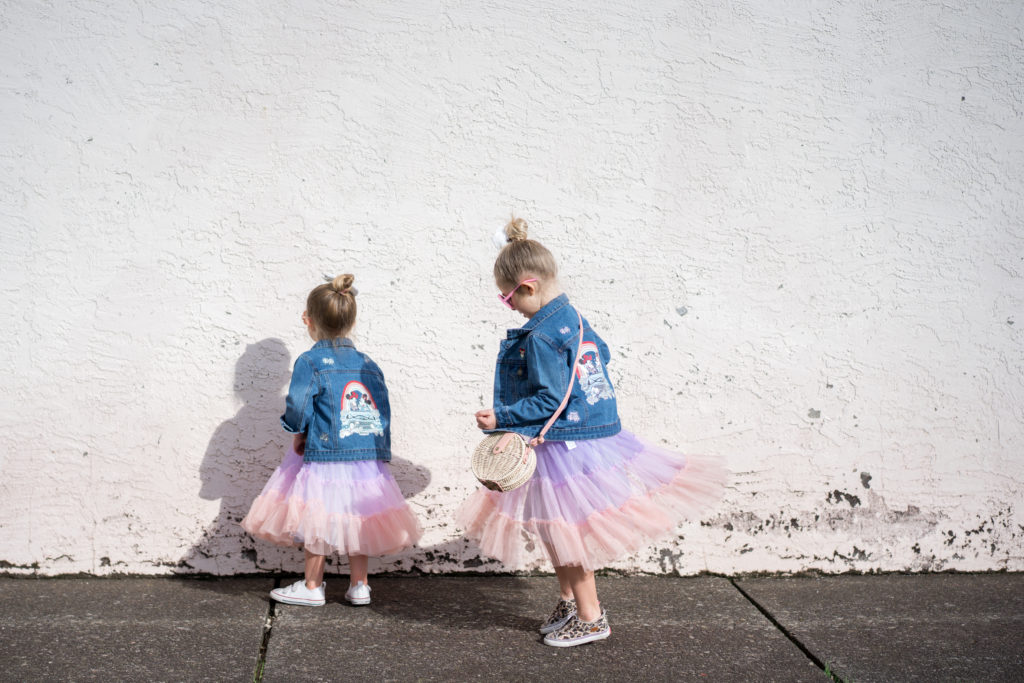 girls twirling in colorful dresses and jean jackets