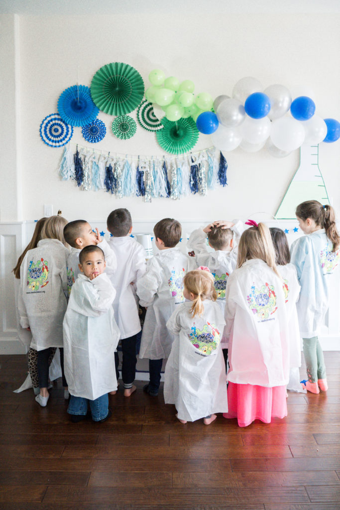Mad Science Themed Birthday Party with kids and balloon garland