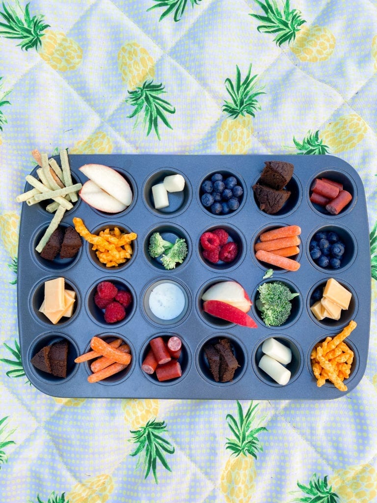 muffin tin filled with snacks 
