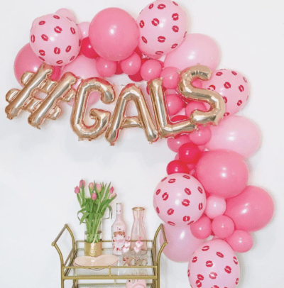 Pink balloon garland with gold bar cart for valentine's day